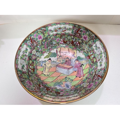 420A - A Chinese famille vert bowl decorated with traditional scenes of figures and flowers, diameter 25.5c... 