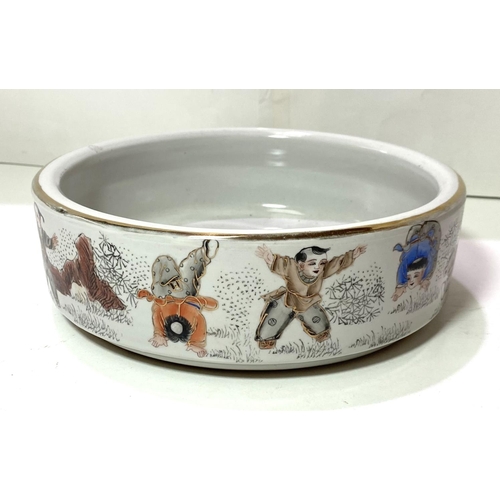 424 - A Chinese Republic period shallow bowl decorated in polychrome with children exercising, orange seal... 