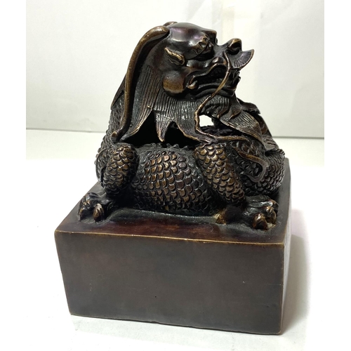 433 - A large Chinese bronze seal with dragon sat on top and seal mark to base, ht 16cm