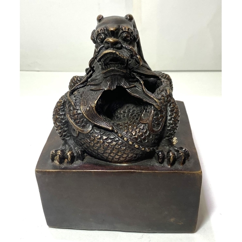 433 - A large Chinese bronze seal with dragon sat on top and seal mark to base, ht 16cm