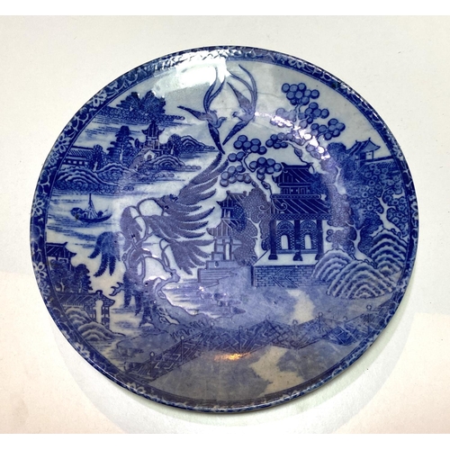 438 - A late 19th/early 20th century Japanese wall plaque in blue and white willow pattern, diameter 30cm;... 