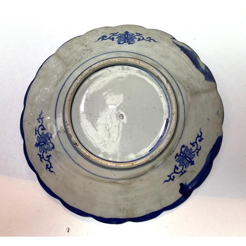 438 - A late 19th/early 20th century Japanese wall plaque in blue and white willow pattern, diameter 30cm;... 