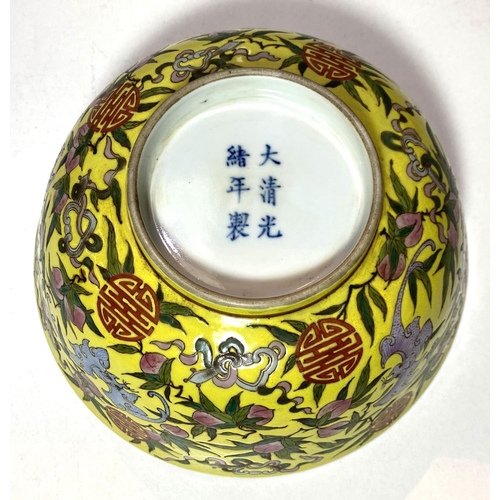 450 - A Chinese yellow ground bowl, decorated to exterior with bats in different colours, 6 character to b... 