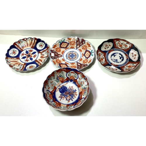 460 - Three late 19th/early 20th century Imari plaques, diameter 21cm; a similar bowl, diameter 8cm