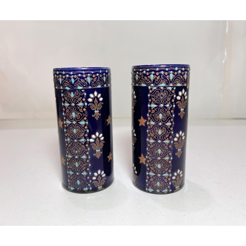 491 - A pair of Boch Freres Keramid vases, blue ground with raised decoration, monogrammed to base No 773,... 