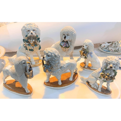 527 - A collection of 6 19th century German porcelain poodles, 3 graduating, some with impressed marks to ... 