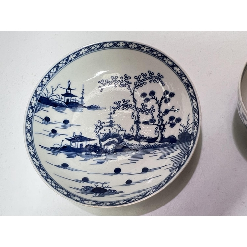 562 - A first period Worcester tea bowl and saucer in blue & white decorated with pagodas in landscape... 