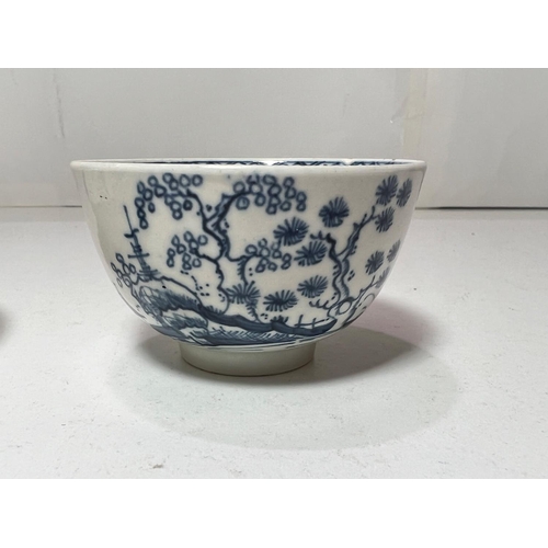 562 - A first period Worcester tea bowl and saucer in blue & white decorated with pagodas in landscape... 