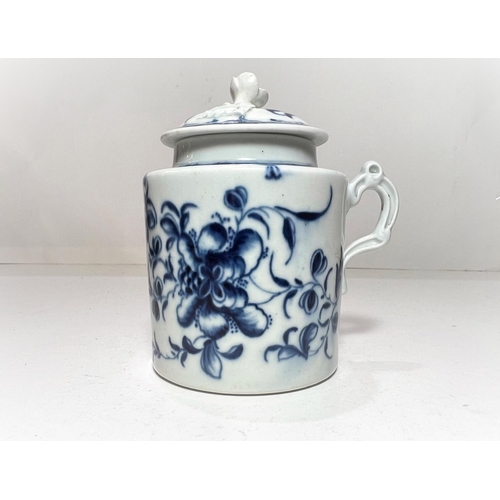 563 - A first period Worcester covered mug with relief flower finial, decorated in blue & white with t... 