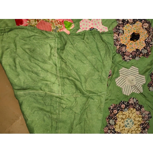 63 - A large patch work quilt (unbacked) with green material with hexagonal pieces in floral shapes, 205x... 