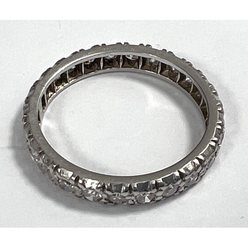 652 - A white metal eternity ring with diamonds in illusion settings, size L, gross 3.3gm