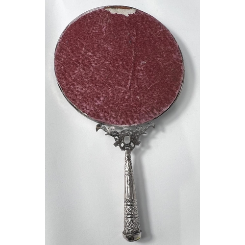 660B - A white metal hand mirror decorated with grapes vines etc 