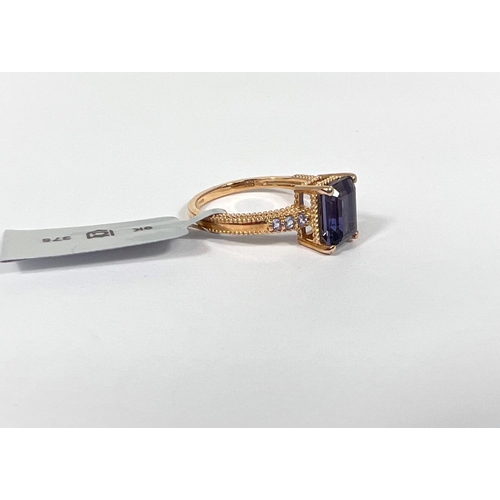 667 - A rectangular blue Bengal lolite dress ring with clear tanzanites to each shoulder, in 9k gold setti... 