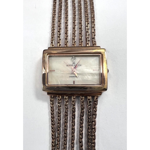 716 - A lady's dress watch by Anne Klein, in gilt metal with 5 strand woven strap and 'lifetime' batt... 