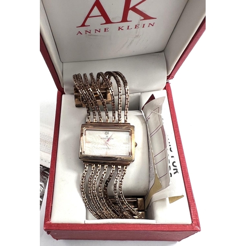 716 - A lady's dress watch by Anne Klein, in gilt metal with 5 strand woven strap and 'lifetime' batt... 