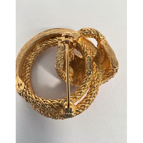 719 - A gilt metal Christian Dior brooch with clear stones, set in rope like twist