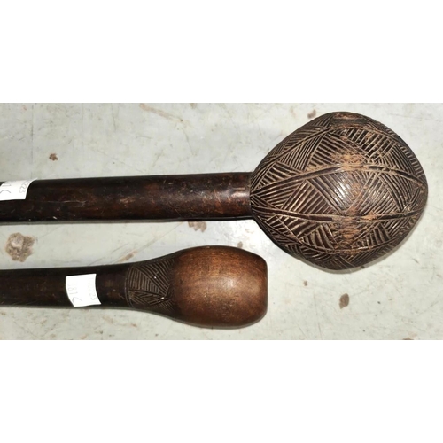 381C - Two Fijian tribal throwing clubs with carved geometric pattern heads (some areas of loss) lengths 56... 