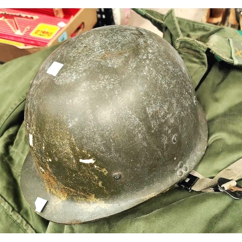 388 - An M1 WWII style American composition helmet with strapping inside, a large green military style ove... 