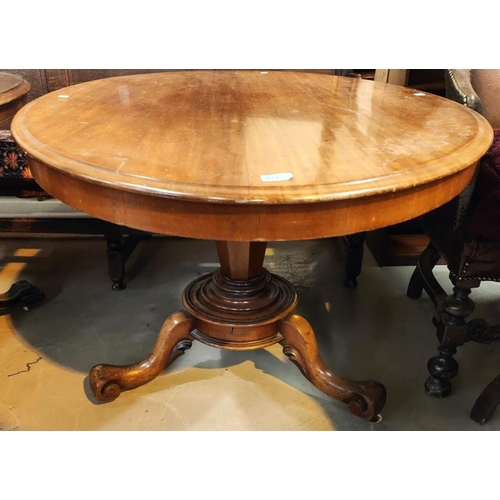 874 - An oval tilt top mahogany supper table with base, 121cm.