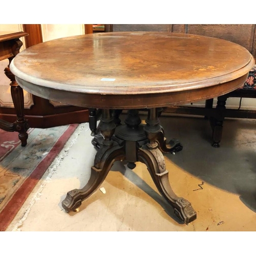 915 - An oval Victorian 1/4 veneered figured walnut Looe table with floral marquetry inlay on quadruple tu... 