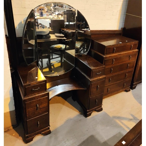 920 - A 1930's oak bedroom suite comprising a five drawer chest with stepped in top drawer, 75cm width, 44... 