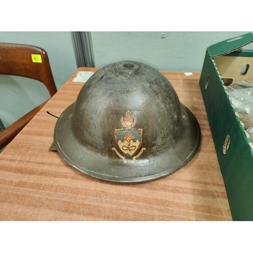 322 - A WWII Civil Defence on Fire Wardens Helmet with crest for the Victoria University of Manchester.