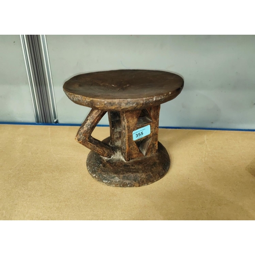 355 - An Ethiopian possibly Jimma or Gurage, wooden stool with carved wooden pillars and a triangular prot... 