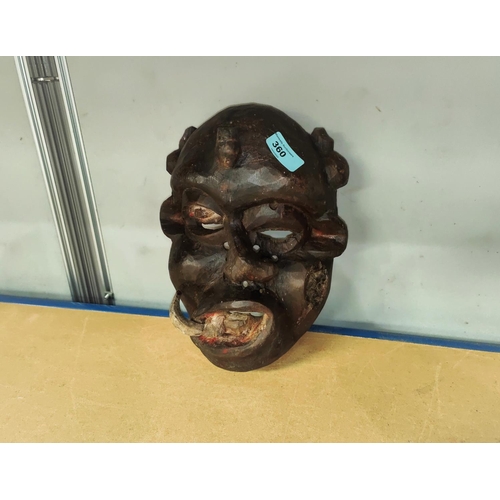 360 - A South East Nigerian painted grotesque face mask from the Ibibio tribe, worn by members of the Ekpo... 