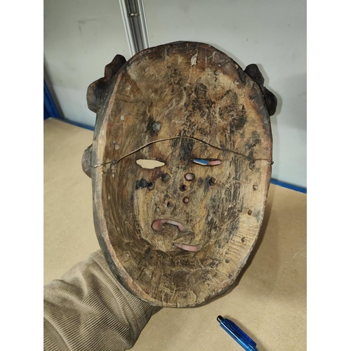 360 - A South East Nigerian painted grotesque face mask from the Ibibio tribe, worn by members of the Ekpo... 