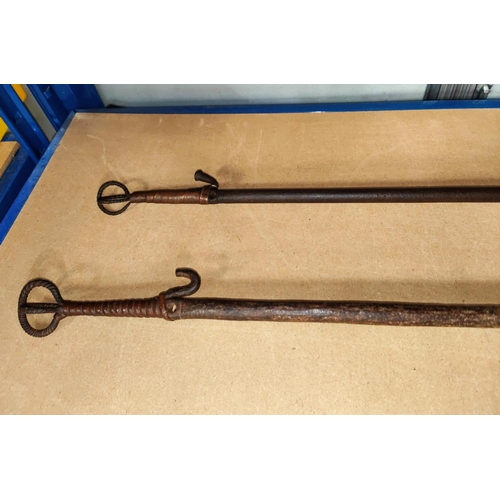 361 - Two South Nigerian Nusubi tribe Iron currency spears, with split central section with hook ends, len... 