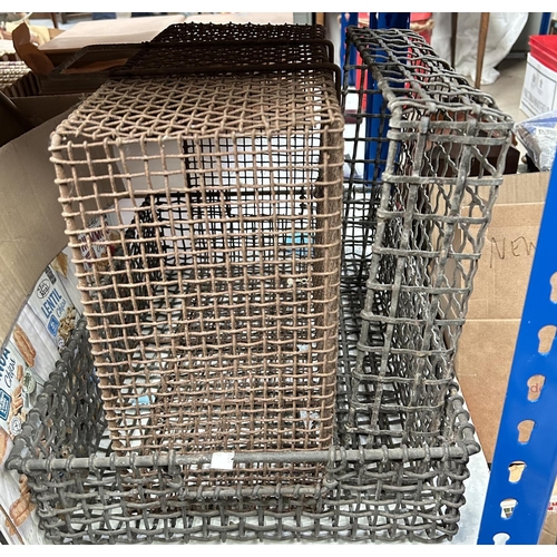 102 - A galvanised steel woven basket with cut out handles, two other similar smaller trays 