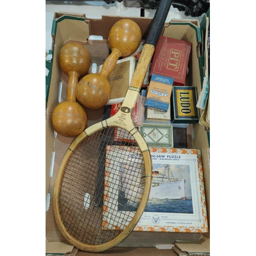 135 - A pair of wooden dumb bells, a vintage tennis racket, a selection of vintage boxed games.