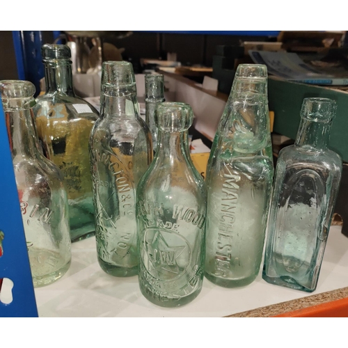 151 - An old copper coal bucket with a selection of 13 various old glass bottles, inc. Manchester brewery ... 