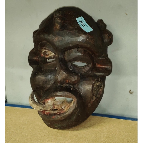 360 - A South East Nigerian painted grotesque face mask from the Ibibio tribe, worn by members of the Ekpo... 