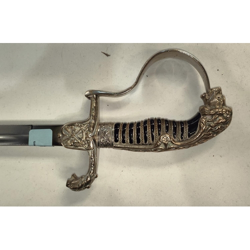 364 - A German officer's sword with lions head finial with hand guard protruding from lion's mouth, black ... 