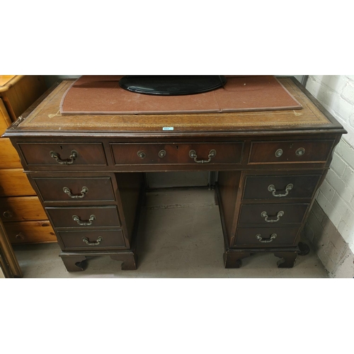 864 - A mahogany desk with green writing insert, three drawers to each pillar and a central draw