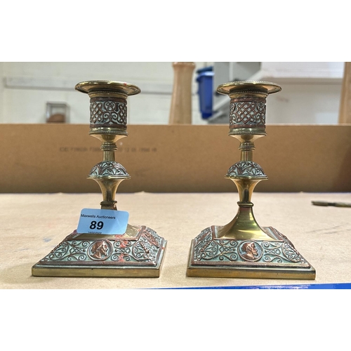 89 - A pair of Arts & Crafts unusual candlesticks in brass and copper with bust portraits to base, he... 