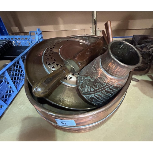 91 - A large copper oval dishes; a selection of copper dishes; a Middle Eastern vase