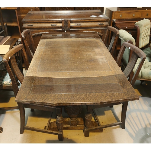 917 - A 1930's carved oak dining suite on bulbous legs comprising: Draw leaf table, 4 chairs and sideboard... 