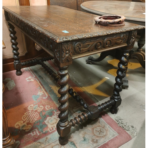 944 - A carved oak plank top library/desk table with barley twist legs and supports, single drawer, natura... 