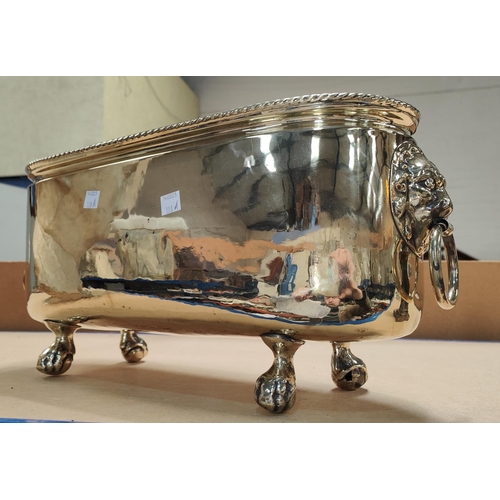 108A - A brass planter with ball and claw feet and lion head handles, length 44cm