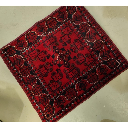 132 - A selection of and embroidered and hand worked linen etc.; a Red Turkey pattern carpet cushion cover... 