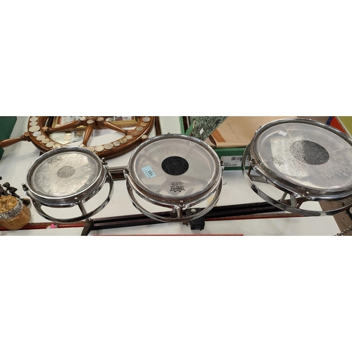 153 - A set of three Remo Weather king graduating drums on bar, a vintage safety helmet (collectors item o... 