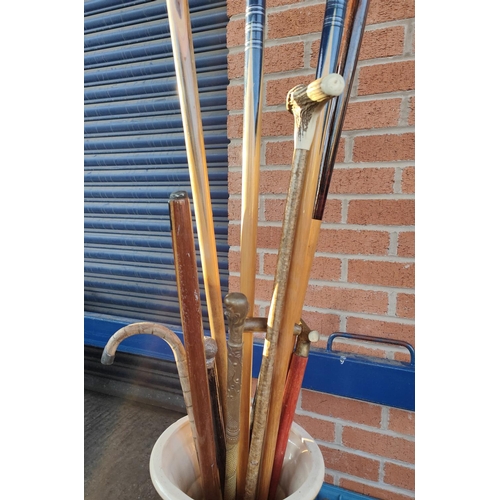 15A - A selection of walking sticks, snooker ques etc