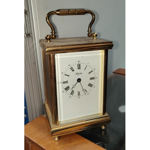 35A - A brass quartz movement carridge clock with bevelled front glass enamel dial