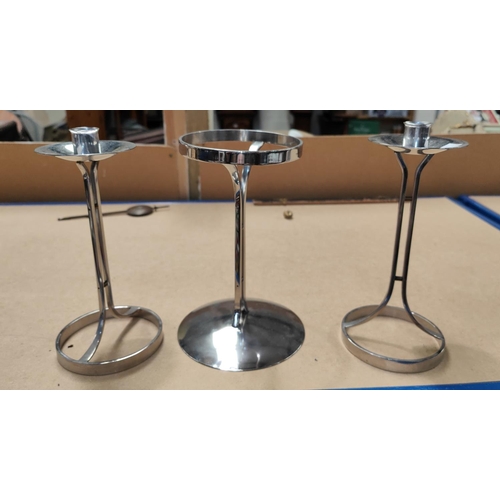 82 - A 1960's pair of stainless steel candlesticks designed by Robert Welch; a similar candle holder