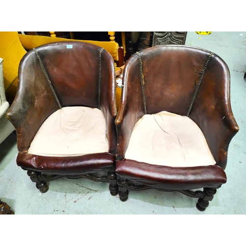 886 - A pair of 1930's club armchairs with brown leather studded backs on turned legs with maroon seats, (... 