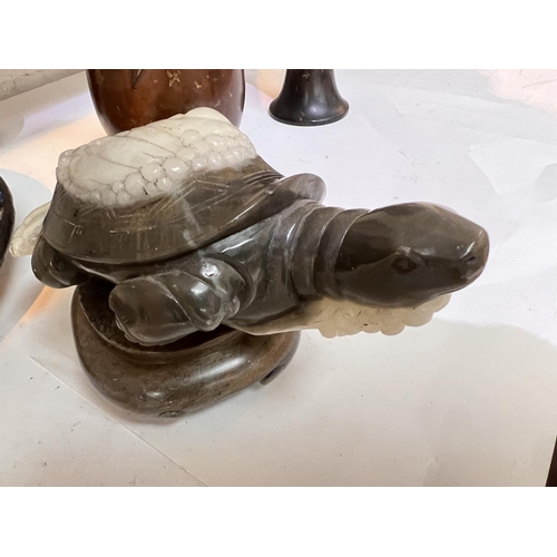 393A - A mottled grey/cream soapstone figure of a turtle in the waves on wooden base length 27cm