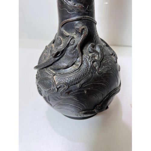 435B - A Chinese bronze vase with dragon and mythical bird decoration, with seal mark to base and wooden st... 