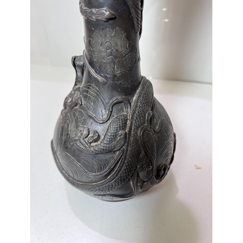 435B - A Chinese bronze vase with dragon and mythical bird decoration, with seal mark to base and wooden st... 